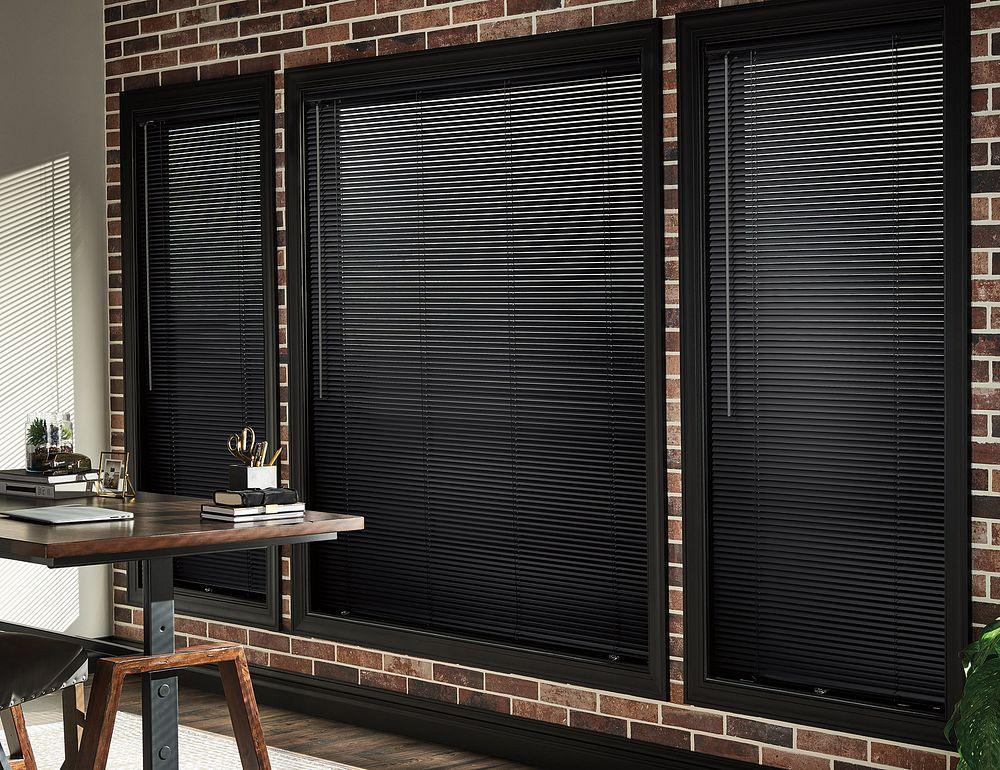 Black aluminium venetian blinds in an office
