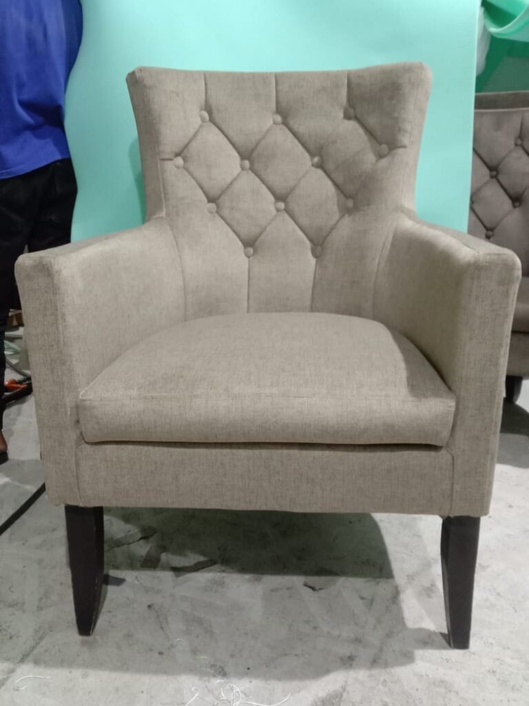Button-tufted armchair upholstered in beige fabric