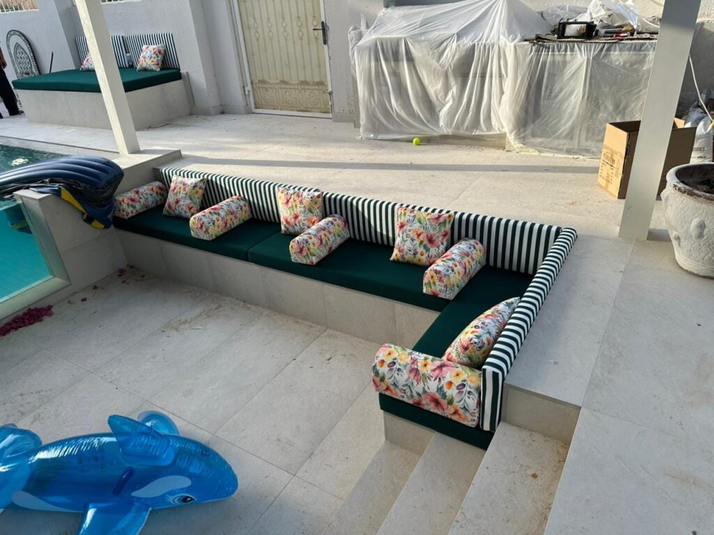Outdoor majlis cushions by a pool
