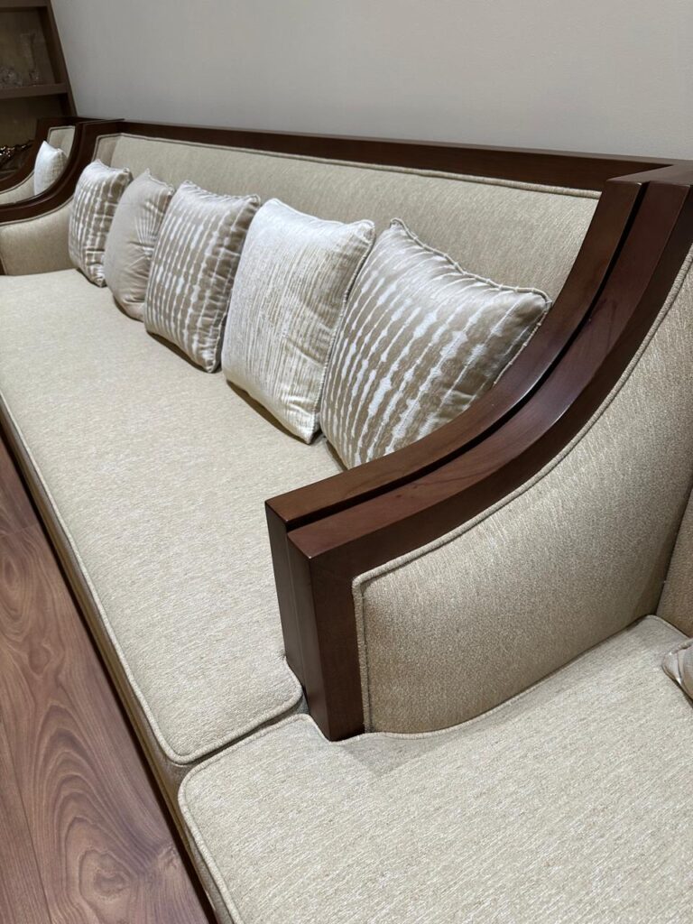 Home Custom upholstered sofa with wooden arm detail in a Dubai villa