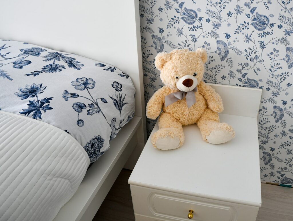 Children's bedroom with floral wallpaper and matching bedding