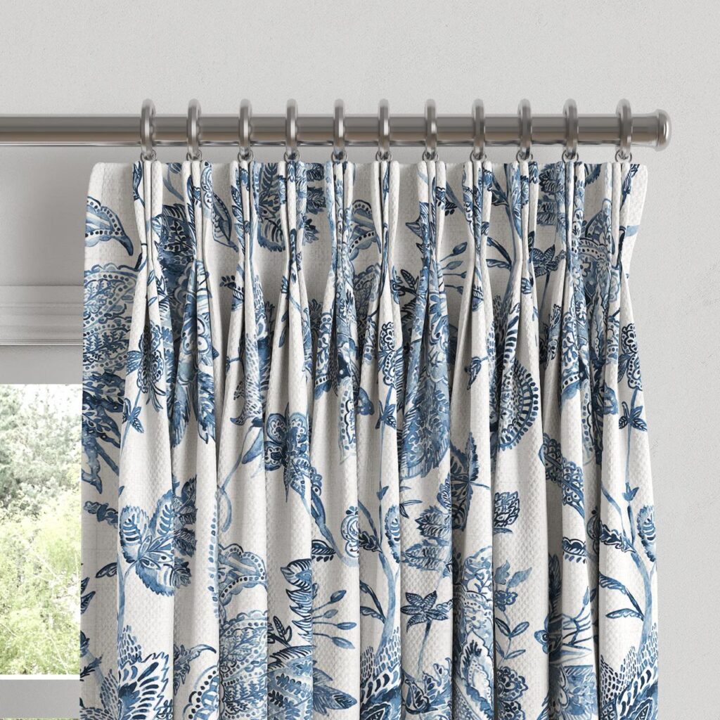 Close-up of printed pinch pleat curtain heading on a rod