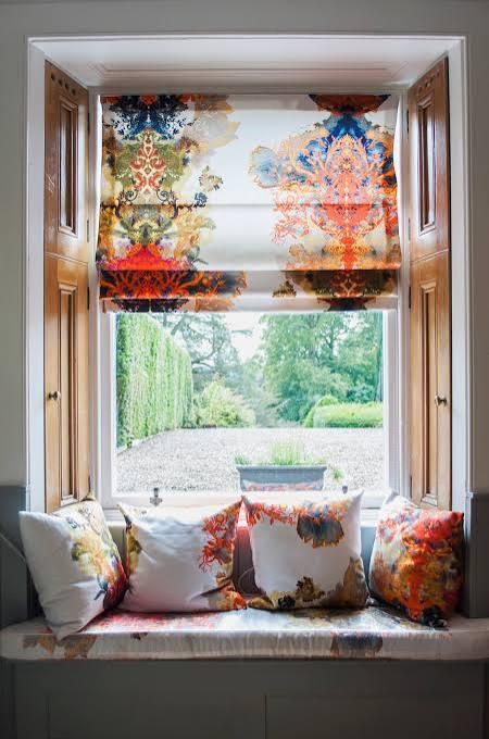 Home Colourful printed Roman blind in a window seat