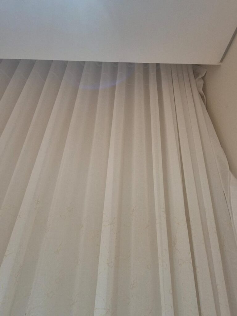 Home White sheer curtains on a ceiling track